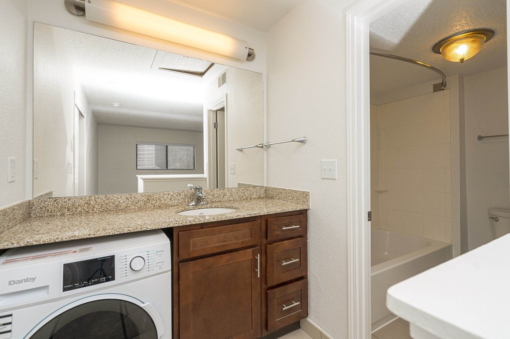a kitchen with a sink and a washer and dryer